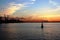 Russia, Volga: Silhouette of a port crane and buoy at sunset