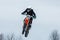 Russia. Vyborg. 02.23.2021 Motorcyclist on a red motorcycle took off in the air on a springboard