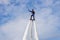 Russia. Vyborg. 05.09.2020. A man flies on a FlyBoard against the background of the sky with clouds. Extreme sport