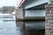 Russia, Vyborg, January 2021. The pillars of the bridge and the water of the bay with ice.