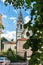 Russia, Yaroslavl, July 2020. View of the bell tower of the Orthodox Church through the foliage of trees.