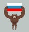 Russian aggressive bear. Angry animal holds Russian flag. Ferocious wild beast. Forest monster with big teeth and claws