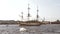 Russian ancient military combat sailing ship on a festive parade in Saint Petersburg in the Neva River and tourist boats