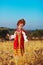 Russian beauty girl in traditional folk costume in field