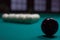 Russian billiards: black and white balls on green table cloth