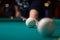 Russian billiards player aims to shoot ball with cue