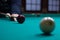 Russian billiards player aims to shoot red ball with cue