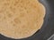 Russian blini crepes pancakes in a pan, close up