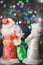 Russian Christmas characters: Ded Moroz Santa and Snegurochka snow girl around the Christmas tree, with gift bag