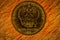 Russian coin of golden alloy. Revers with seal of Bank of Russia depicting twin headed eagle with heraldic signs. Words in russian