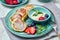 Russian cottage cheese pancakes Syrniki with berries and sour cream on light wooden background. Healthy breakfast