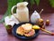 Russian cuisine : crepes pancakes on black cast iron with oak flakes on wooden background with rustic milk jug, honey and nesting