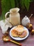 Russian cuisine : crepes pancakes with oak flakes on brown wooden background with rustic milk jug and nesting dolls matrioshka ve