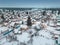 Russian dacha village near the lake and forest in winter, aerial view