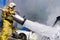 Russian firefighter puts out a fire, a large jet of white foam, hydrant, extinguishing, epic