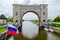 Russian flag on background of arch of navigation lock, Uglich