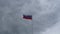 Russian flag fluttering in the wind on a foggy sky background. Grey and rainy cloudy atmosphere