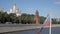Russian flag in front of Kremlin walls, towers and churches