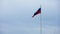 Russian flag waving on overcast gray sky background at day time