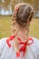 Russian girl Slavic appearance with braids with red ribbons in t