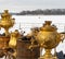 Russian gold samovar with hot drink on the table in winter, luxury teapot, antiques