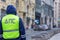 Russian inspector of traffic police patrol standing on the street in the center of Moscow in yellow vest jacket with a sign DPS