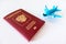 Russian international passport and a blue plane on white background. Travel, journey and flying concept