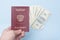 Russian international passport in the man`s hand. Dollars. Blue