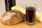 Russian kvass in bottle and mug, round loaf of bread