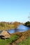 Russian landscape with river Kamenka, lodge for birds and Church