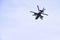 Russian military combat attack helicopter K-52 Alligator flies against a blue sky and clouds