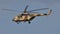 Russian military helicopter flying in the blue sky