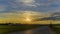 Russian Northern sunset, the landscape of the field and the barn with the forest