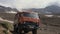 Russian off-road extreme expedition truck KamAZ driving on mountain road