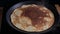 Russian pancake is fried in a pan. The process of making thin pancakes for carnival.