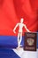 Russian pass and wooden dummy figurine on Russian flag.