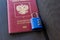 Russian passport on lock. Blue padlock with combination. Wooden background