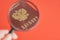 Russian passport and a magnifying glass on a red background