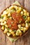 Russian Pozharsky cutlets with a side dish of fried potatoes close-up in a plate. vertical top view