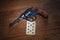 Russian roulette - Ten of Clubs plaing card and revolver with one cartridge in drum