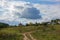 Russian rural landscape in the fall, village houses near the forest. Sky with rain clouds