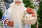 Russian santa claus holds decorations for the christmas tree in the store.