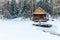 Russian sauna banja house in winter forest nearby the lake with ice-hole