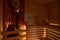 Russian sauna bathhouse with muted intimate light from under the bottom of bench wooden lantern hygrometer thermometer