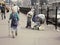 Russian seniors - poorly dressed old women with cane walking at the street