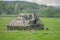 Russian soldiers hiding behind a tank