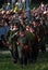 Russian soldiers-reenactors march with guns.