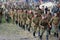 Russian soldiers-reenactors march with guns.