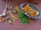 Russian and spanish rustic cuisine : preparation for goulash of duck with greenery, carrot, garlic, juniper berries, and spice on