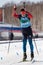 Russian sportsman biathlete Kapustin Aleksandr skiing on ski track distance biathlon arena. Junior biathlon competitions